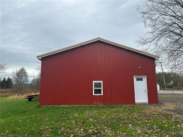 view of outbuilding with a yard