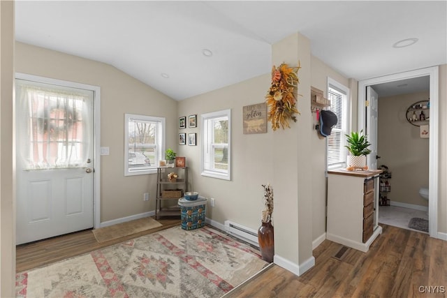 foyer entrance featuring lofted ceiling, dark wood-type flooring, and a baseboard radiator