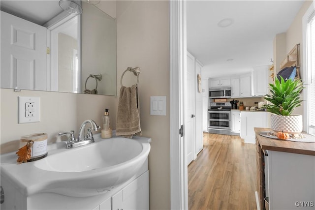 bathroom with sink and hardwood / wood-style floors