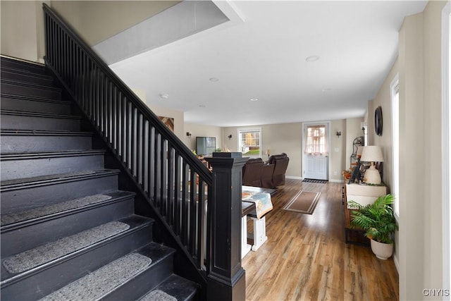 stairway with hardwood / wood-style floors