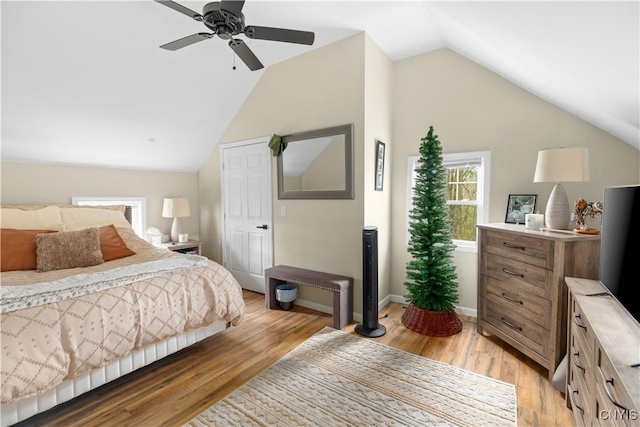 bedroom with lofted ceiling, ceiling fan, and light wood-type flooring