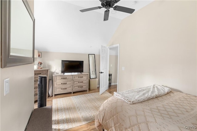 bedroom featuring vaulted ceiling, ceiling fan, and light hardwood / wood-style flooring