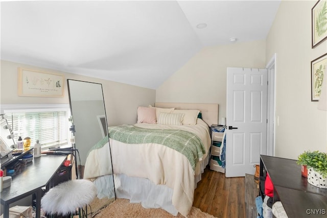 bedroom with vaulted ceiling and wood-type flooring