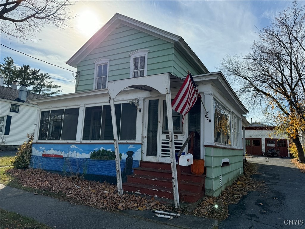 view of front of house with a sunroom