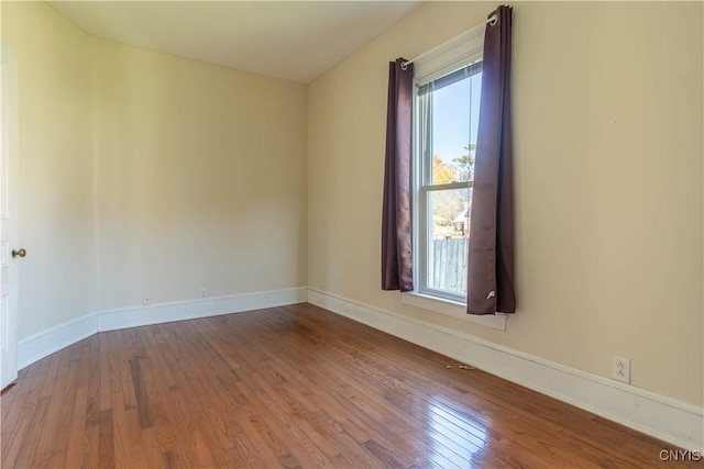 empty room with hardwood / wood-style flooring