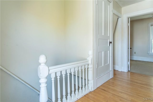 corridor with light hardwood / wood-style floors