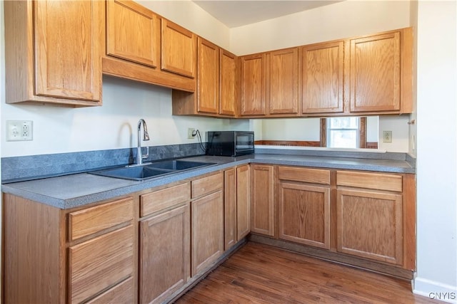 kitchen featuring sink and dark wood-type flooring