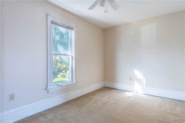 carpeted spare room featuring ceiling fan