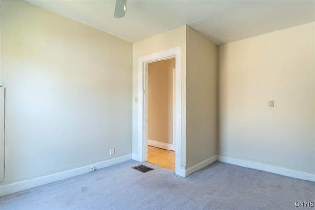 unfurnished room with light colored carpet