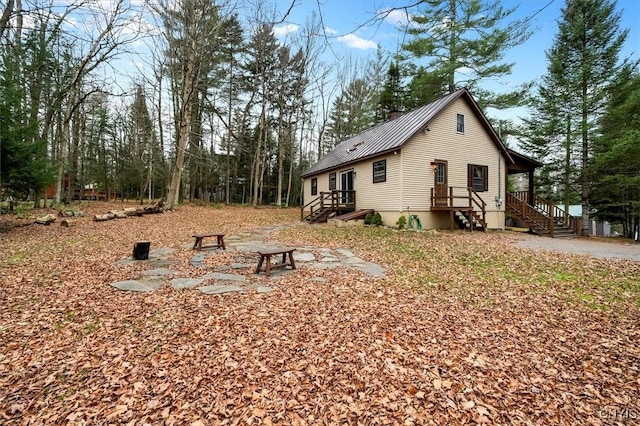 back of property featuring a fire pit