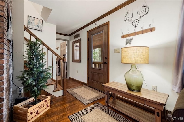 foyer featuring dark hardwood / wood-style flooring and ornamental molding