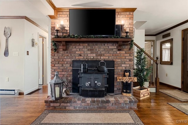 living room featuring a wood stove, ornamental molding, and hardwood / wood-style flooring