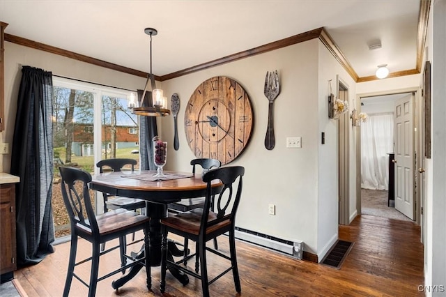 dining room featuring a chandelier, dark hardwood / wood-style flooring, and crown molding