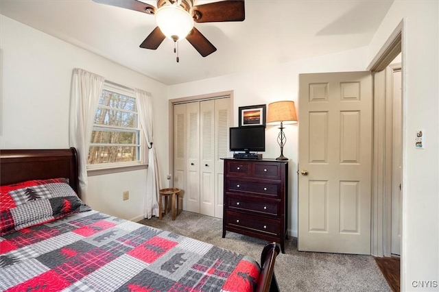 carpeted bedroom featuring ceiling fan and a closet