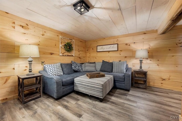 living room featuring wooden walls, hardwood / wood-style floors, and wooden ceiling