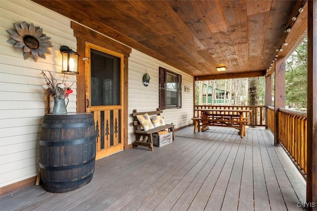 wooden terrace with a porch