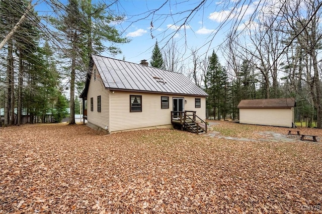 rear view of house featuring a storage unit