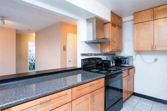 kitchen with light tile patterned flooring, wall chimney exhaust hood, dark stone countertops, backsplash, and black / electric stove