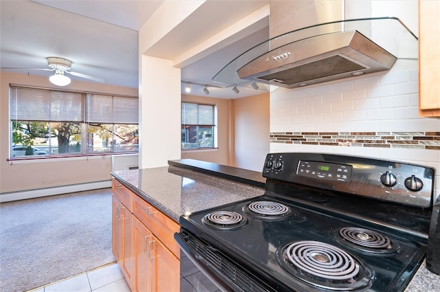 kitchen with a baseboard radiator, a healthy amount of sunlight, island range hood, and black range with electric stovetop