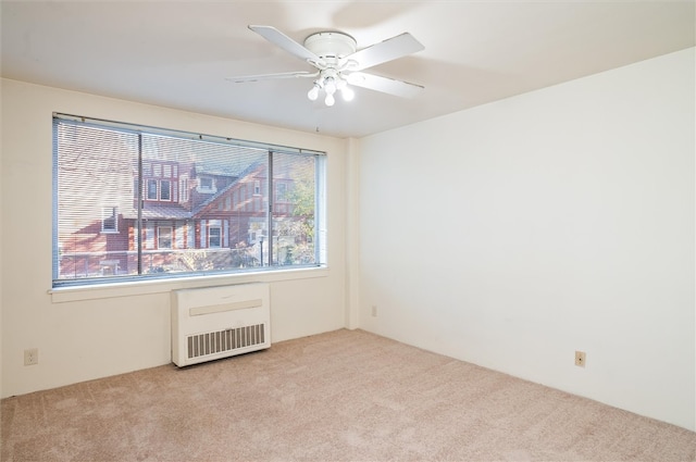 empty room featuring ceiling fan and light colored carpet