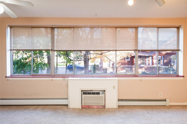 interior space featuring a baseboard heating unit, light colored carpet, and ceiling fan