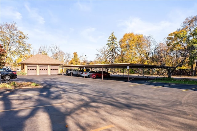 view of parking featuring a garage and a carport