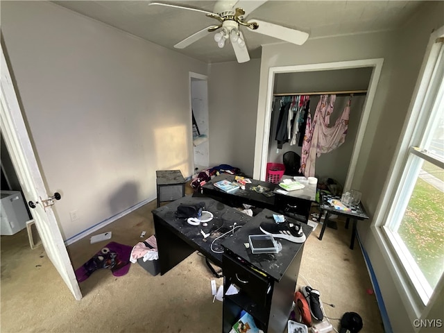 carpeted bedroom with ceiling fan and a closet