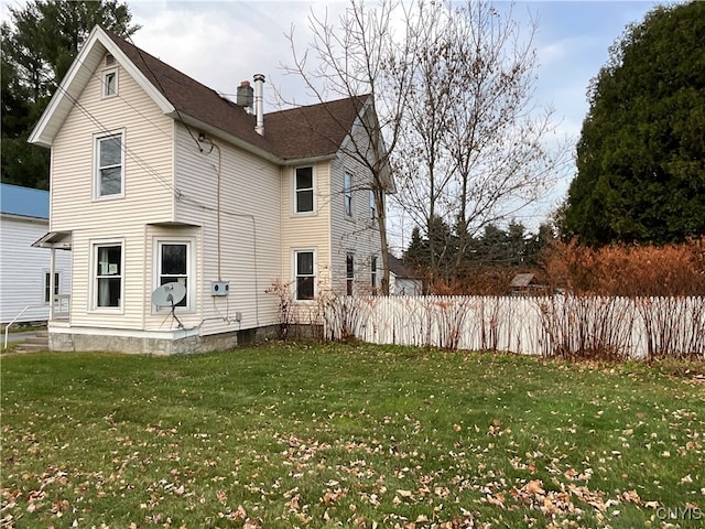 rear view of house with a lawn