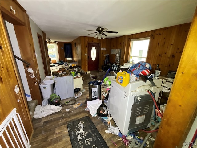 misc room with wood walls, ceiling fan, and dark hardwood / wood-style flooring