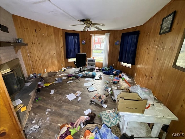 353 S James St, Wilna, NY 13619 - living area with wood walls, a ceiling fan, a brick fireplace, and wood finished floors