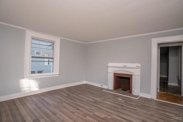 unfurnished living room with crown molding, dark hardwood / wood-style floors, and a brick fireplace