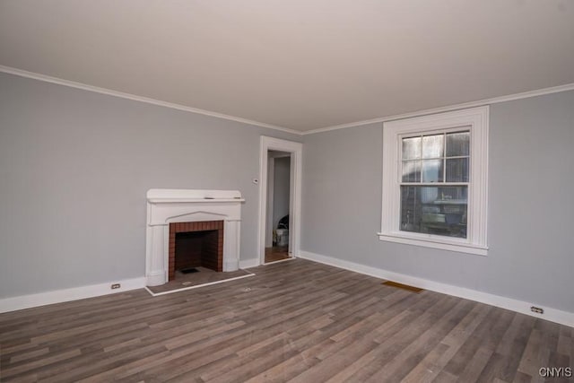 unfurnished living room with ornamental molding, a brick fireplace, and dark wood-type flooring