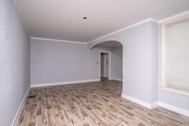 spare room featuring ornamental molding and wood-type flooring