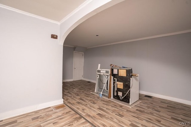 interior space featuring crown molding and hardwood / wood-style floors