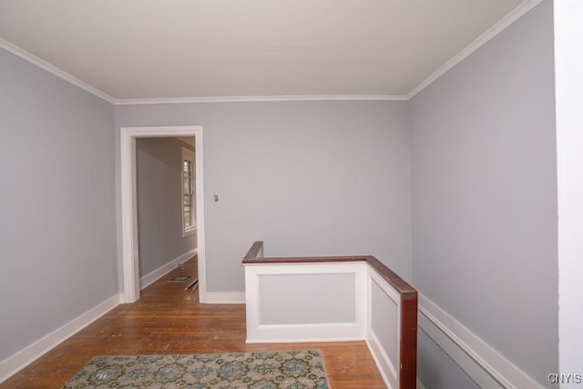 corridor with dark wood-type flooring and crown molding