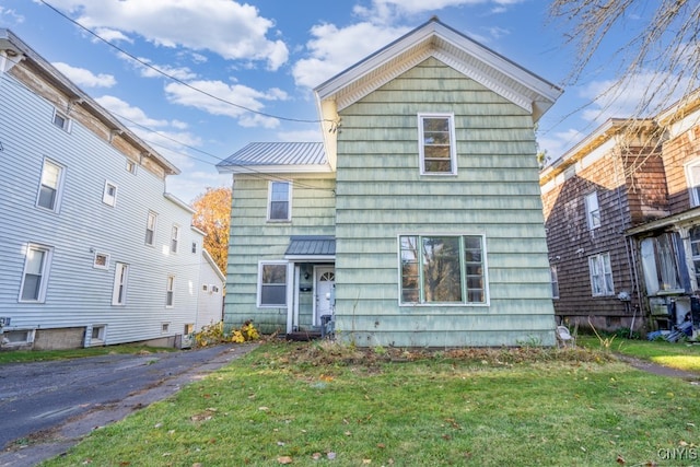 back of house with a lawn