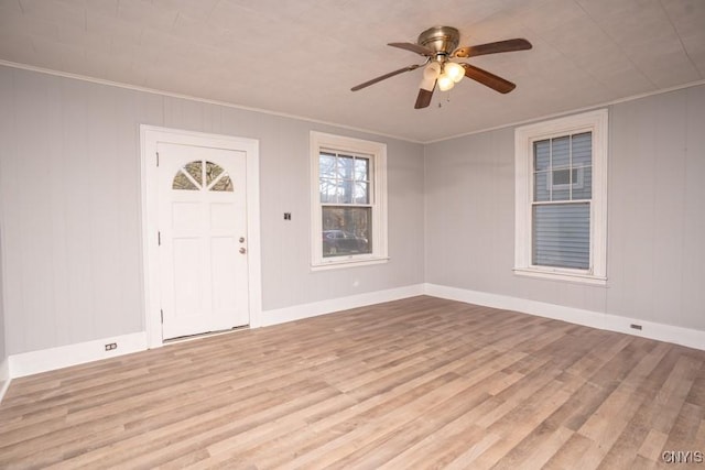 foyer with crown molding, ceiling fan, and light wood-type flooring