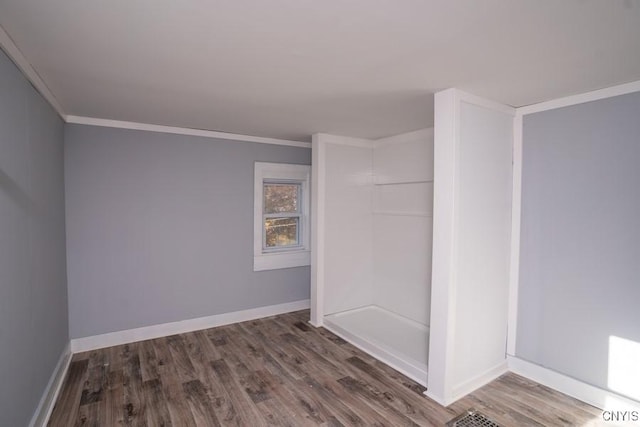 unfurnished room with crown molding and dark wood-type flooring