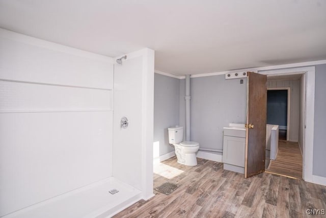 bathroom with wood-type flooring, ornamental molding, vanity, walk in shower, and toilet