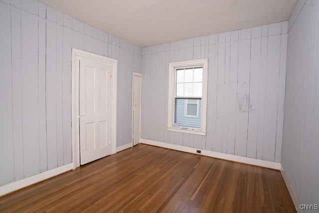 unfurnished room with dark hardwood / wood-style floors