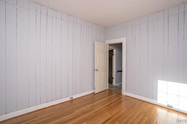 unfurnished room with hardwood / wood-style floors