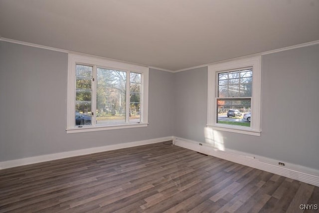 spare room featuring dark hardwood / wood-style flooring and ornamental molding