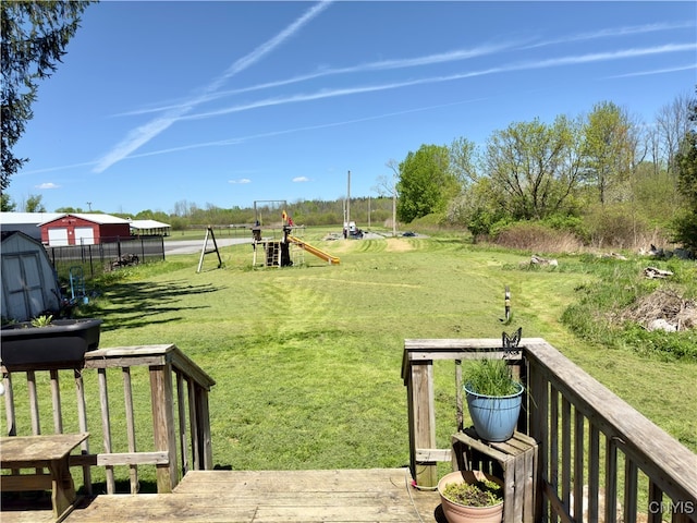 view of yard featuring a playground and a storage shed