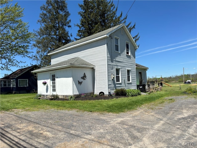 view of property exterior with a lawn