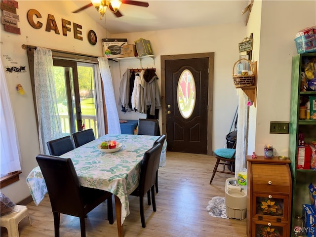 dining area featuring ceiling fan, lofted ceiling, and light hardwood / wood-style floors