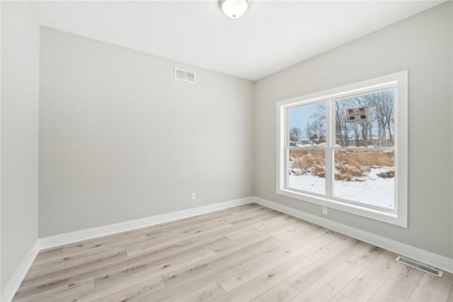 spare room with light hardwood / wood-style flooring