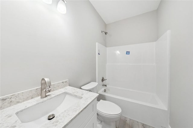 full bathroom with toilet, vanity, tub / shower combination, and hardwood / wood-style flooring