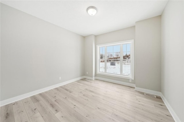 spare room with light hardwood / wood-style floors