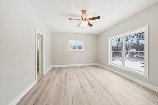 empty room featuring ceiling fan and light hardwood / wood-style floors