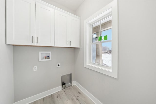 washroom featuring light hardwood / wood-style flooring, washer hookup, electric dryer hookup, and cabinets